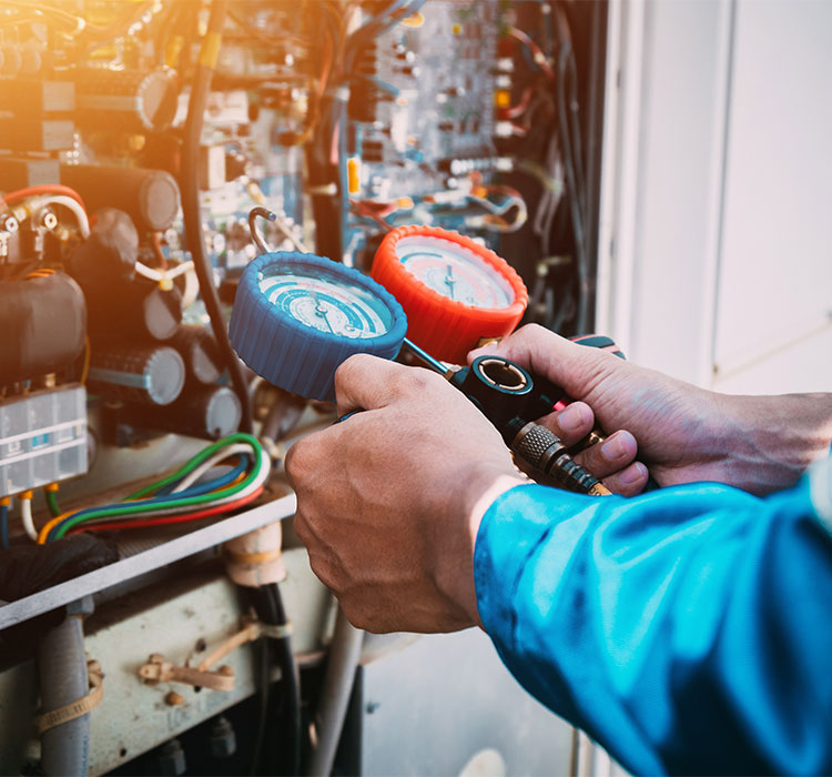 Technician is checking air conditioner refrigerant leak.