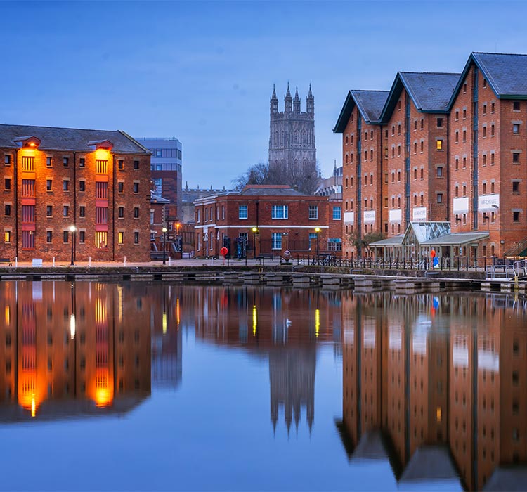 Gloucester docks and Cathedral reflected in the quay on Sharpness at twilight
